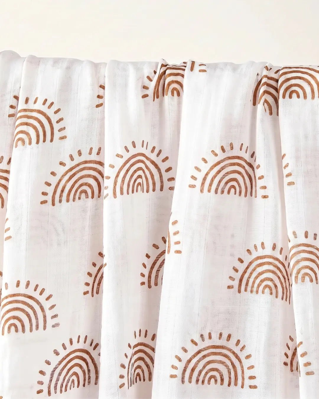 Muslin swaddle print in Aurora (white base, earth coloured rainbows)