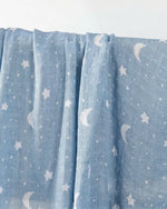 Muslin swaddle print in Lunar (blue base, white stars)