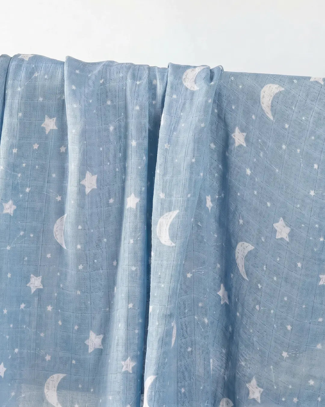 Muslin swaddle print in Lunar (blue base, white stars)