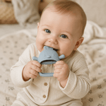 Close-up of baby chewing Nest silicone teether in Kiama (blue)