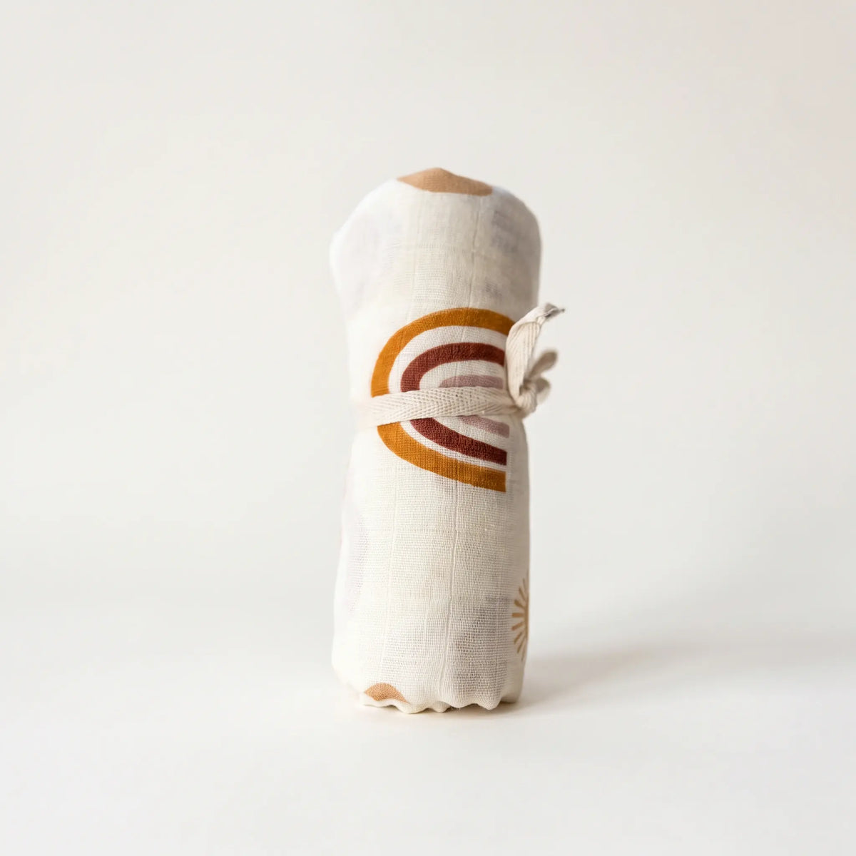 Drift muslin baby swaddle in Aurora rainbow and sun print