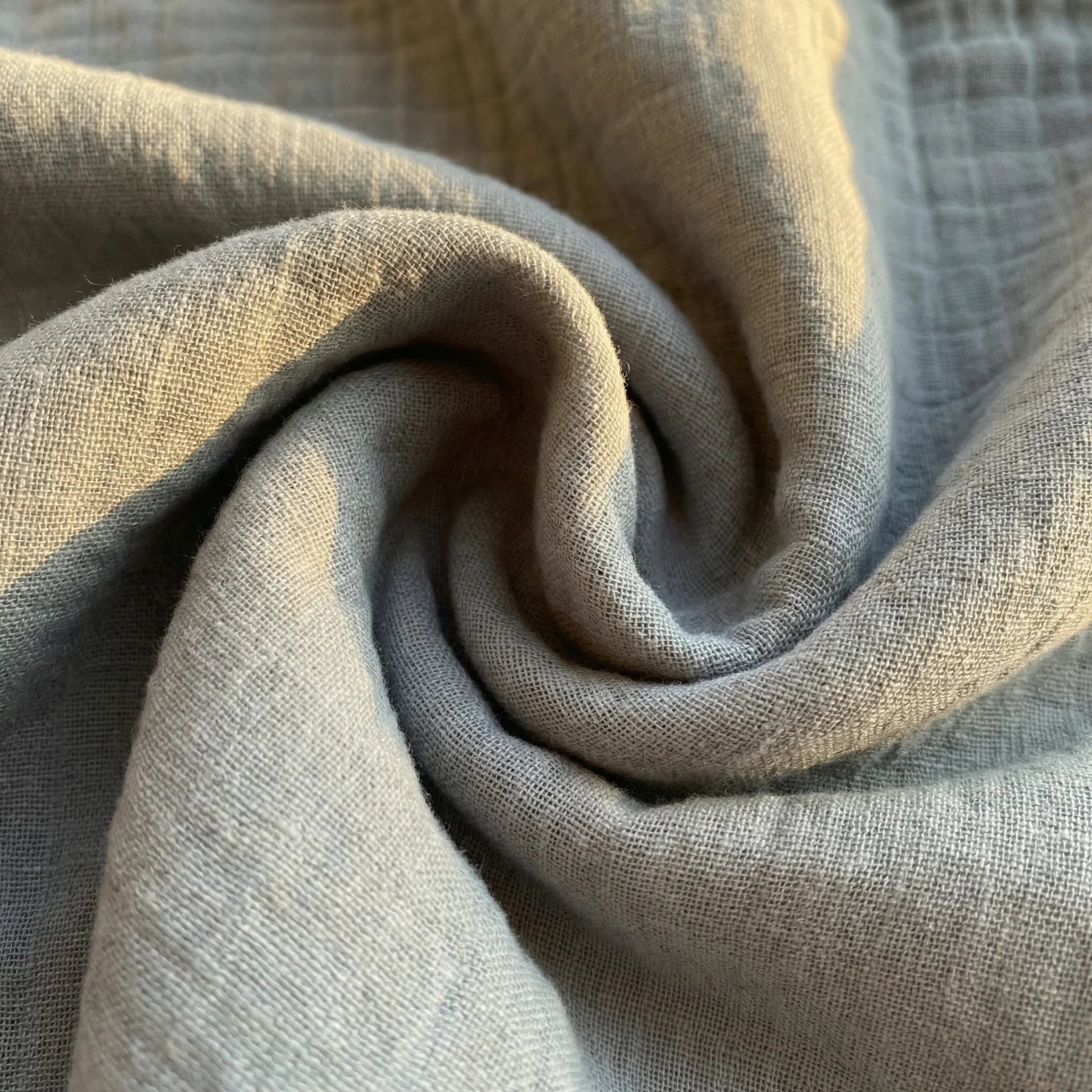 Soft blue baby swaddle blanket folded fabric texture detail