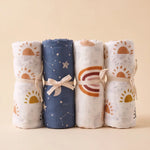 Drift muslin baby swaddles in Ember, Lunar, Soleil and Aurora prints