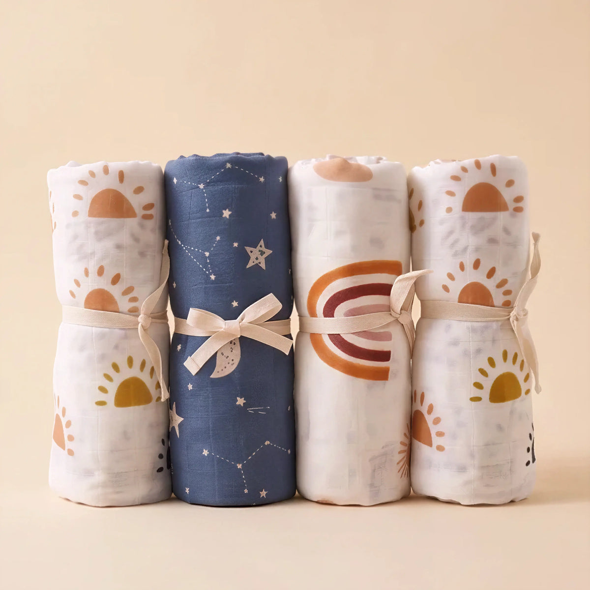Drift muslin baby swaddles in Ember, Lunar, Soleil and Aurora prints