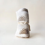 Drift muslin baby swaddle in Ember boho arches print
