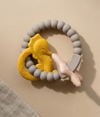 Silicone baby teether with textured silicone beads in golden sand tones