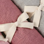Bamboo muslin baby swaddle in Broome (raspberry pink) close up photo