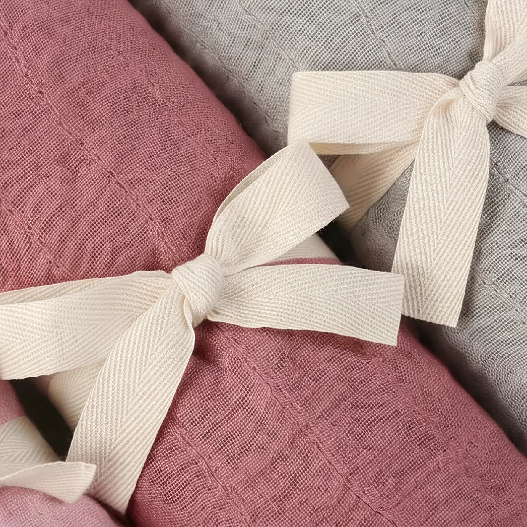 Bamboo muslin baby swaddle in Broome (raspberry pink) close up photo