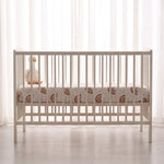 Sunbeam fitted baby cot sheet, wide shot on white cot mattress - Honey & Sage