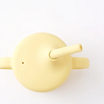 Silicone sippy cup with straw in Dawn (bright yellow), side view