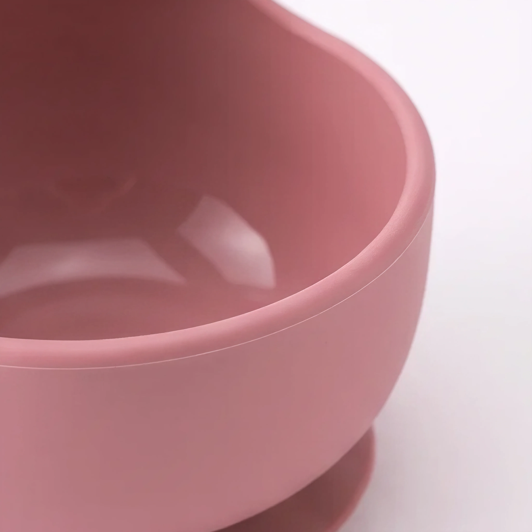 Silicone suction bowl in Rosewood (blush pink), close-up showing suction base