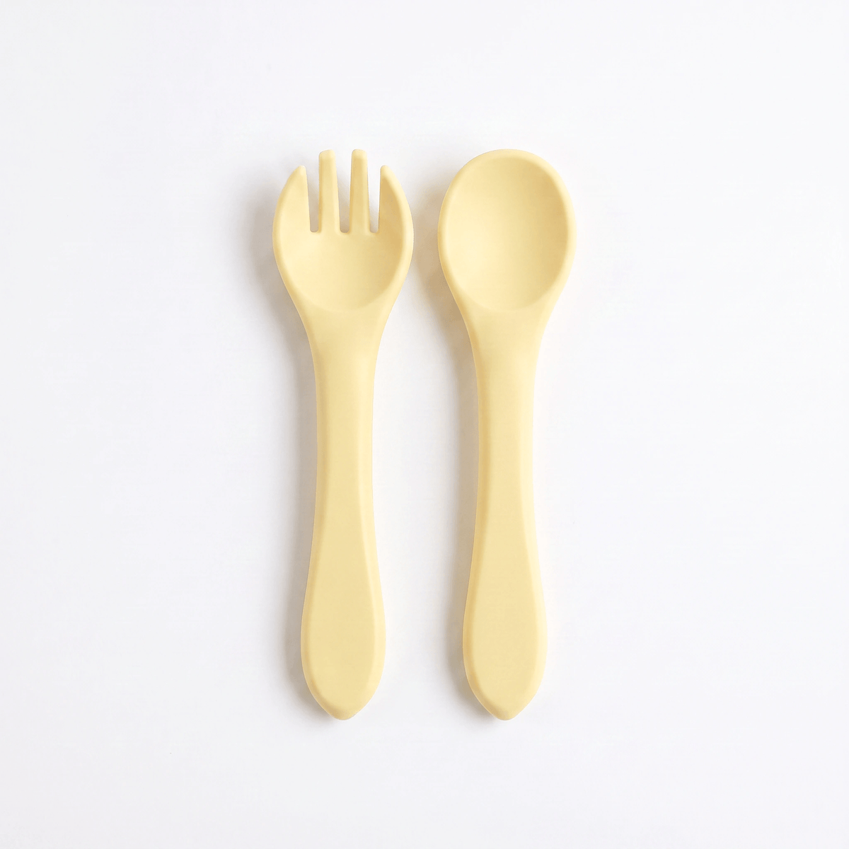 Silicone baby utensils set in Dawn (bright yellow) – spoon and fork