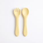 Silicone baby utensils set in Dawn (bright yellow) – spoon and fork