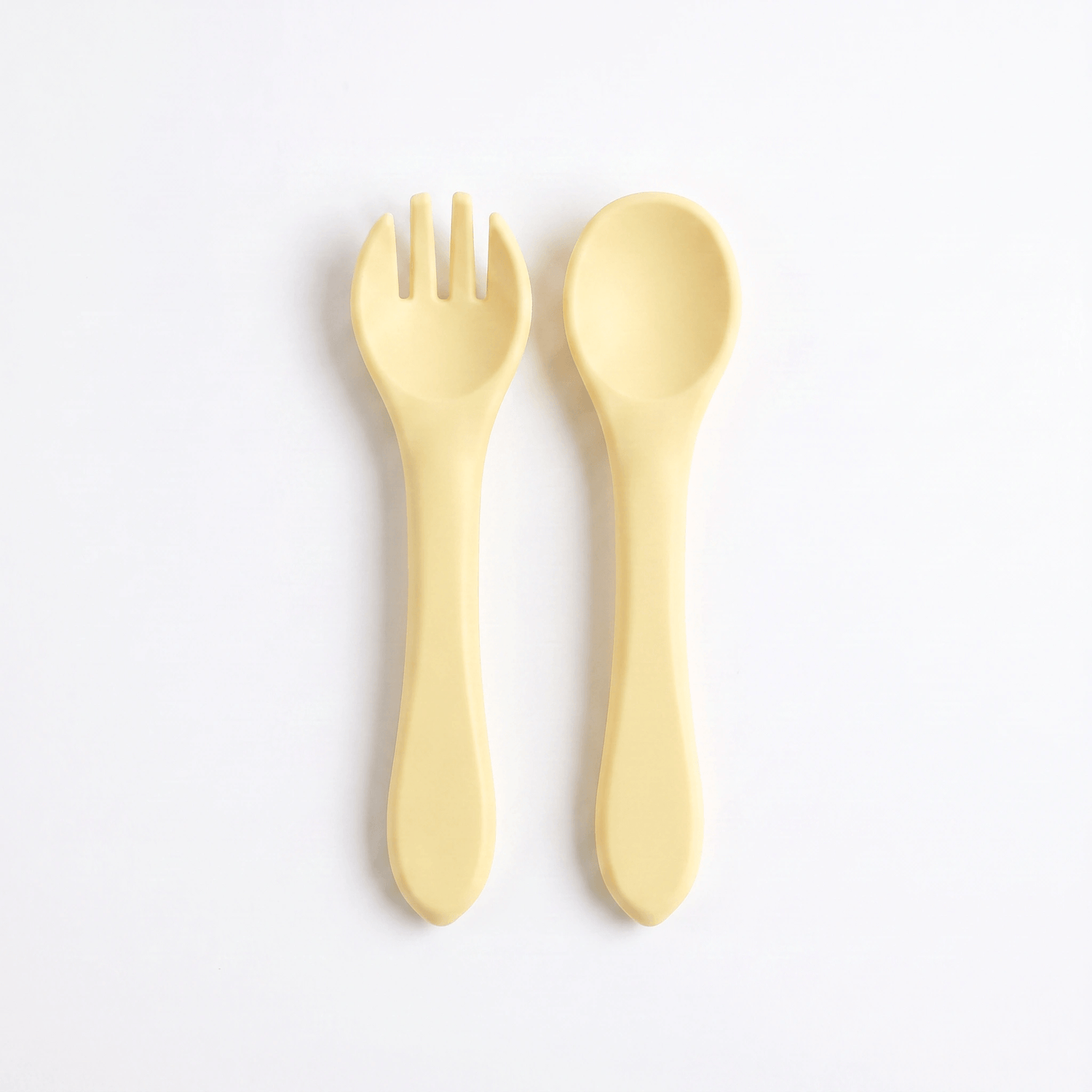 Silicone baby utensils set in Dawn (bright yellow) – spoon and fork