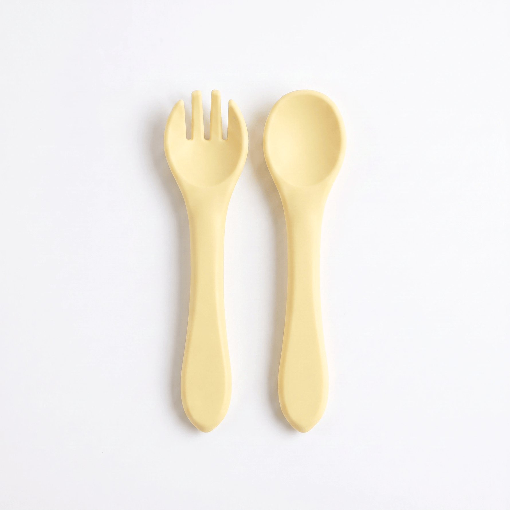 Silicone baby utensils set in Dawn (bright yellow) – spoon and fork