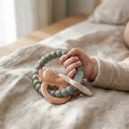 Muted green and peach silicone and wood baby teether 
