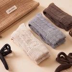 Little Comforts for Mum gift bundle with cable knit socks, a woven pouch and hair claw clips