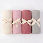 Bamboo baby swaddles in Esperance, Airlie, Broome and Stirling, folded and tied with ribbon