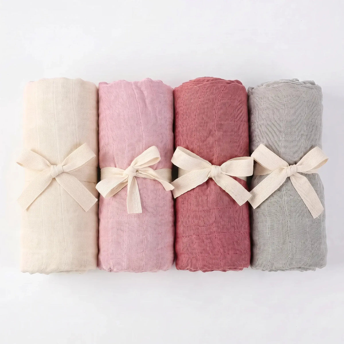 Bamboo baby swaddles in Esperance, Airlie, Broome and Stirling, folded and tied with ribbon