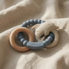 Muted blue silicone baby teether with beechwood ring