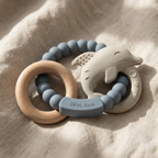 Muted blue silicone baby teether with beechwood ring