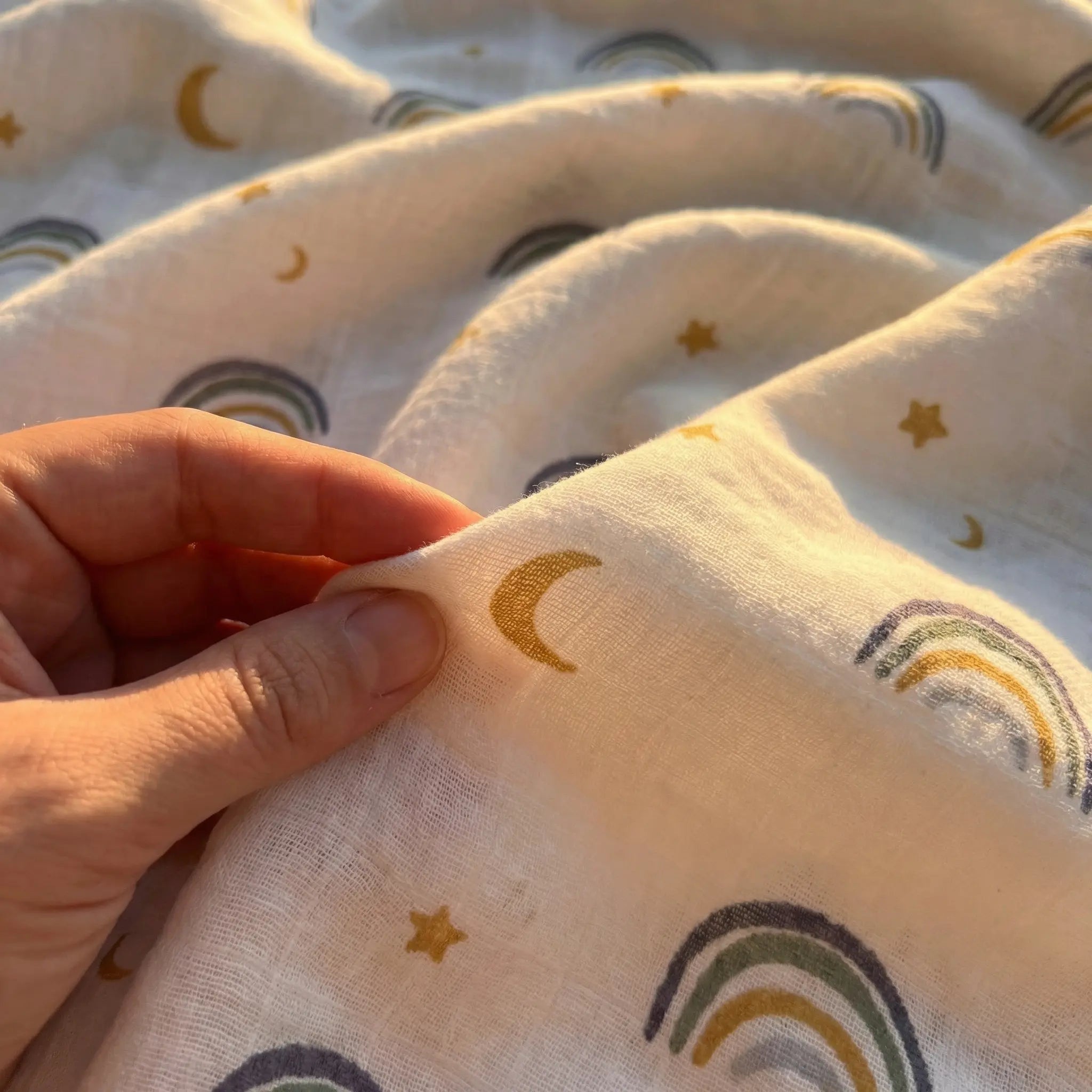 Light neutral baby swaddle soft fabric folds minimal aesthetic