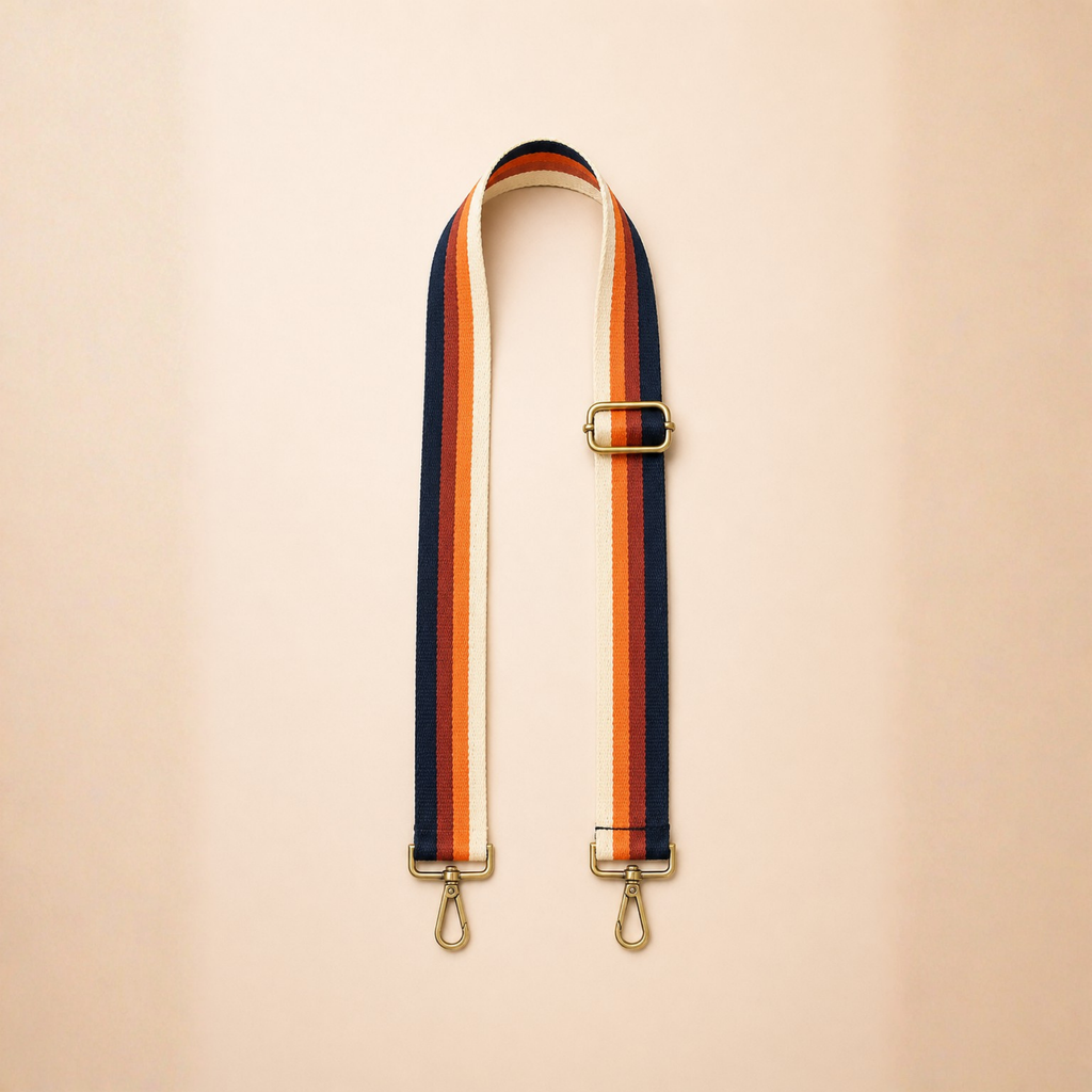Warm reed toned adjustable bag strap with gold hardware minimal flat lay
