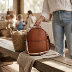 Reed interchangeable nappy bag strap worn on Flint nappy bag backpack, lifestyle shot - Honey & Sage