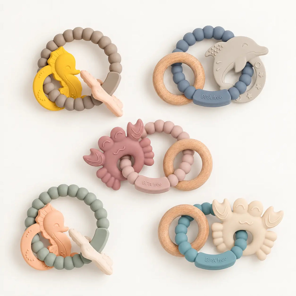 Reef silicone and beechwood baby teethers in assorted colourways, flat lay