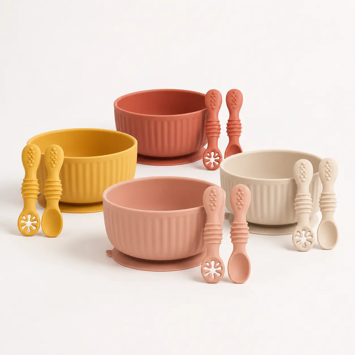 Ribbed silicone suction bowl and utensils sets in Mustard Yellow, Muted Clay, Raw Sienna and Shifting Sand