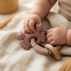 Soft pink silicone baby teether with beechwood ring