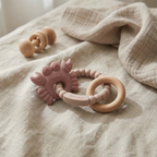 Soft pink silicone baby teether with beechwood ring