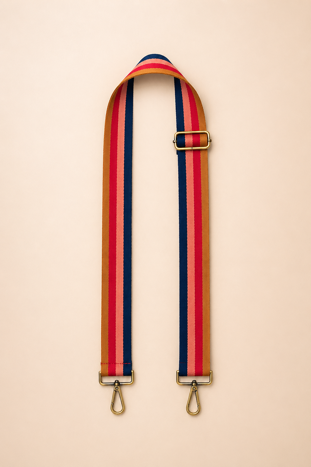 Rust berry toned interchangeable bag strap with gold hardware flat lay