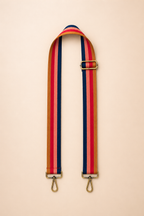Rust berry toned interchangeable bag strap with gold hardware flat lay