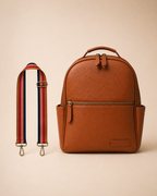 Rust berry toned interchangeable bag strap with gold hardware flat lay with alder backpack