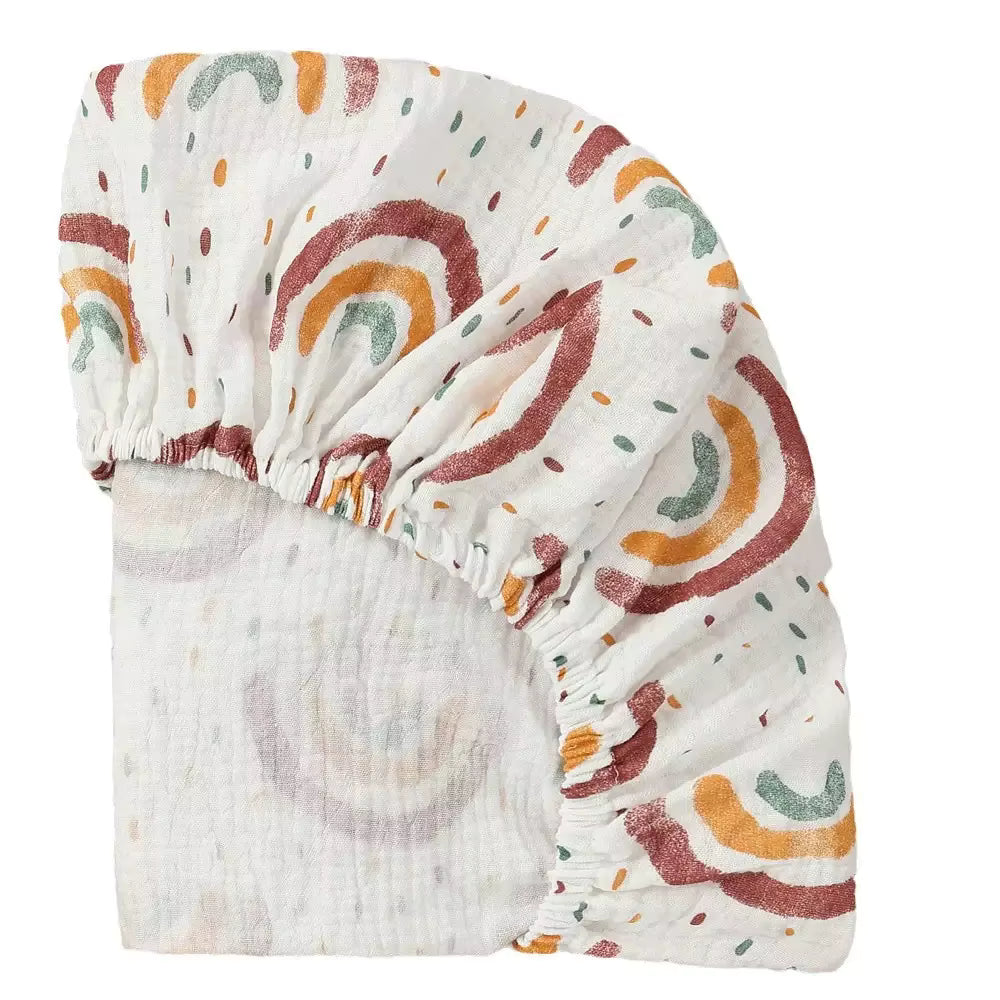 Patterned cot sheet sunbeam print in warm neutral tones
