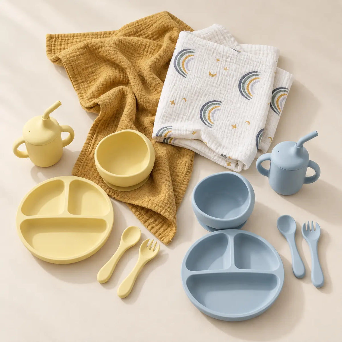 Swaddle and solids baby gift bundle, silicone feeding set flat lay with muslin swaddle and knit blanket