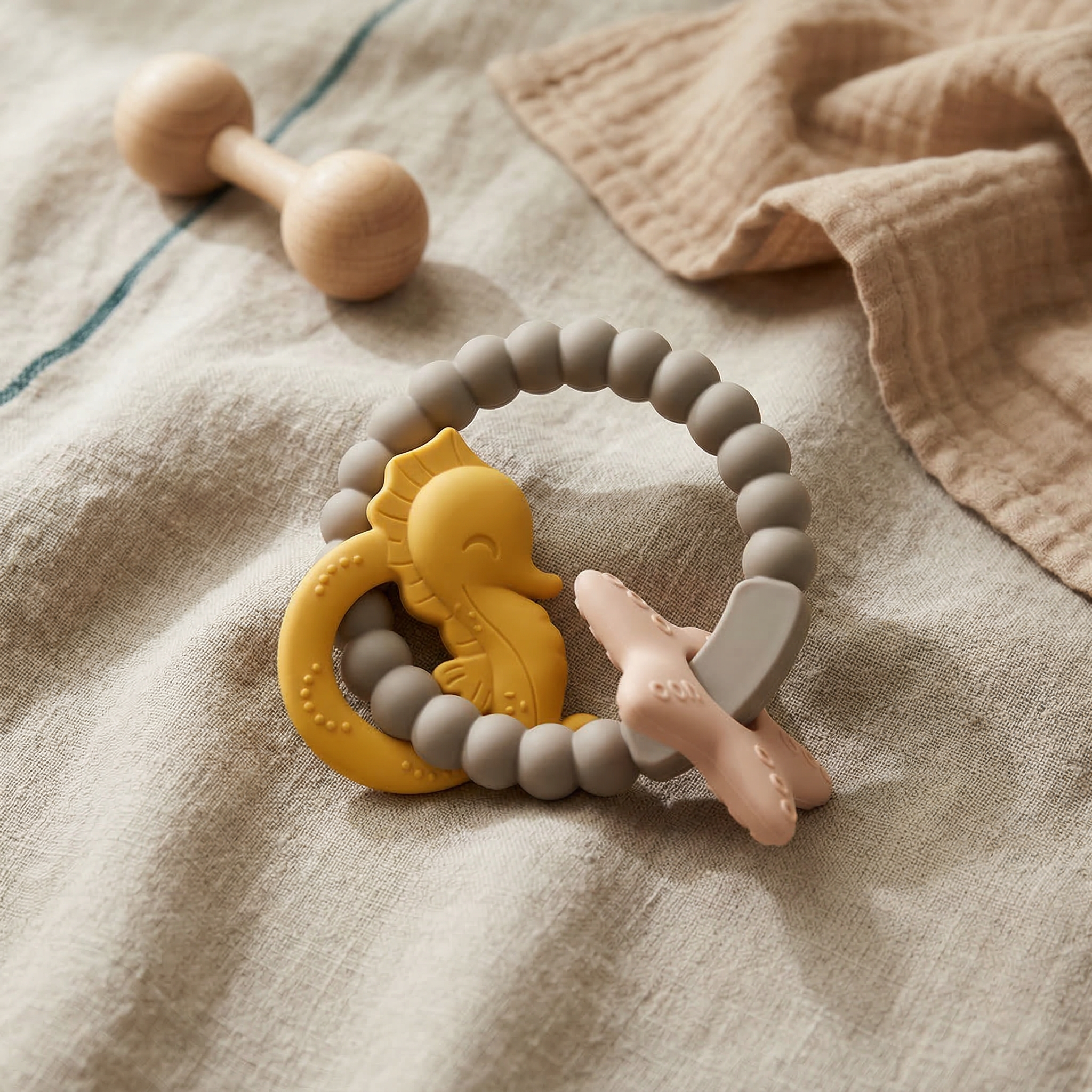 Neutral baby teether flat lay with textured silicone bead