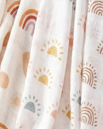 Muslin swaddle print in Soleil (white base, pastel suns)